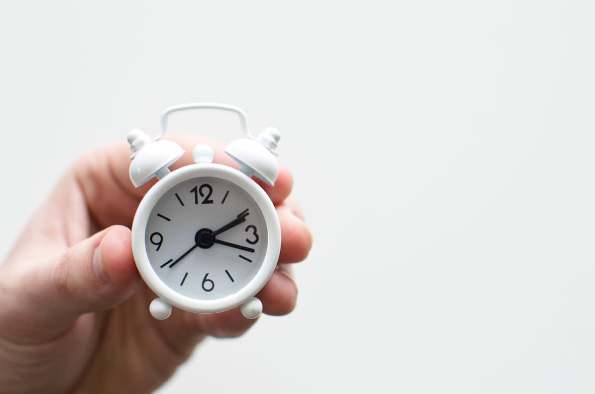 Clock on a desk representing time saved with online tools